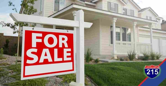 Suburban home with a "for sale" sign.